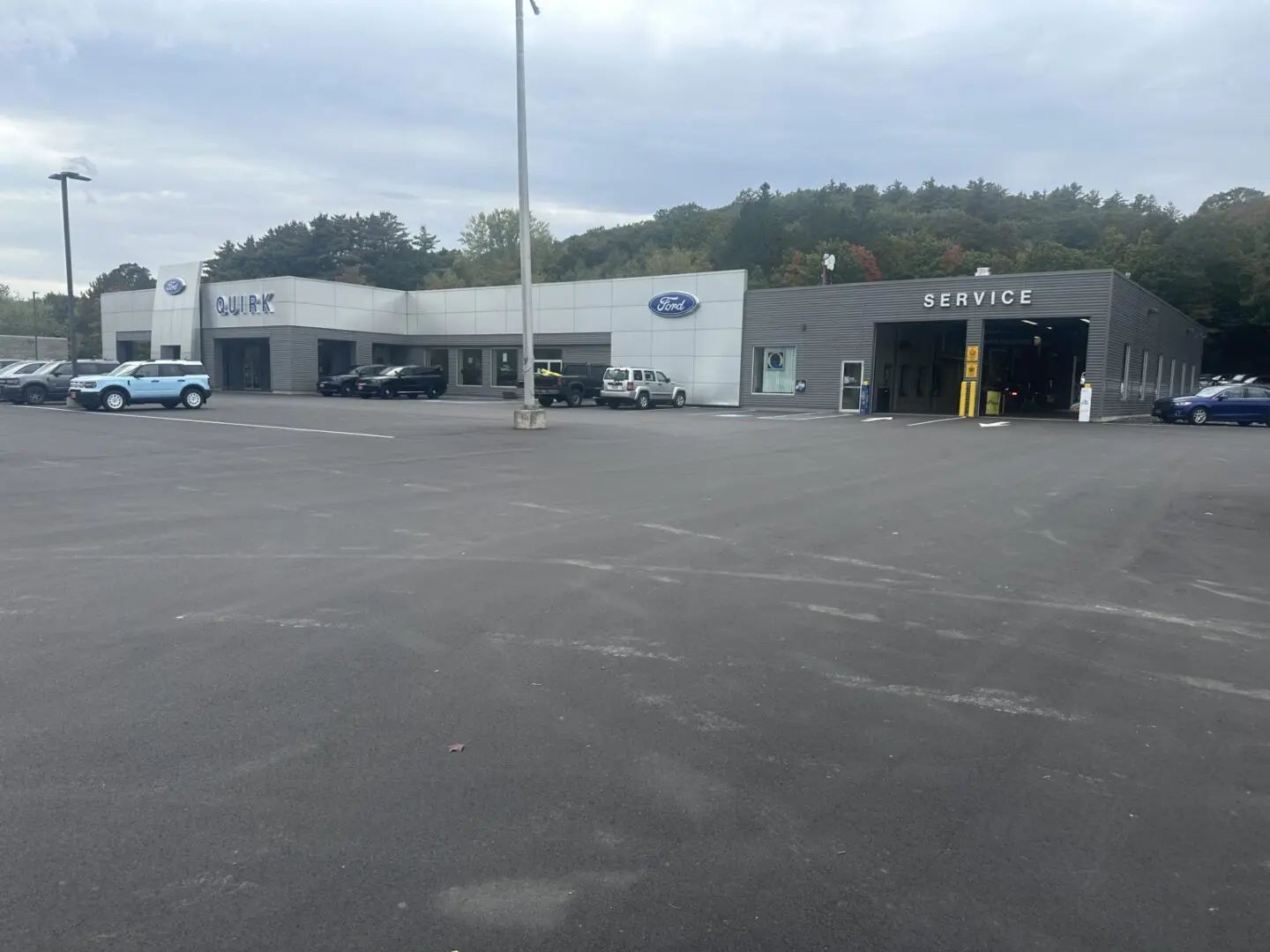 A car dealership with a lot of cars parked in it